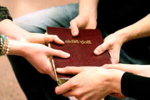 group of students holding a bible